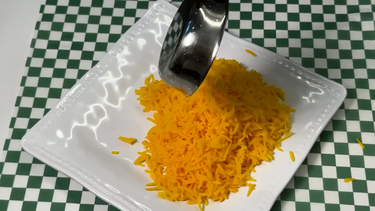 Rice and meat being plated